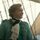Rhys Darby as a very well dressed pirate standing on his boat in Our Flag Means Death.